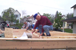 [Photo 1: Louis Berra helping on the construction of the homes]