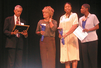 [Photo 2: Three ladies receiving certificates from their director]
