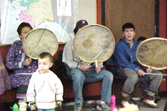 [Photo 2: A little boy making his first dance to the drumming of his elders]