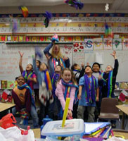 [Photo 3: Mountain View Elementary School students accepting their hats and mittens.]