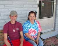 [Photo 1: Christian and Christina on the front porch of their new home.]