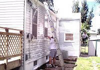 [Photo 2:  Home selected for rehab work is "sponsored"  by a team of volunteers.]