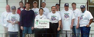 [Photo 3:  HUD and other volunteers at the Tate's home.]