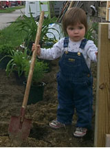 [Photo 2: A young gardener pitches in.]