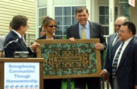[Photo 1: Secretary Martinez and Chairman Brendsel presenting a "welcome mat" to Crystal Mack.]