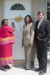 [Photo 2: Ms. Gilliam cuts the ribbon, joined by Ms. Owens and Mr. Stoker]