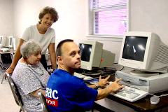 [Photo 2: John and Mary were using the new computers]