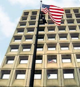 [Photo: American flag and POW-MIA flag in front of the HUD building.]