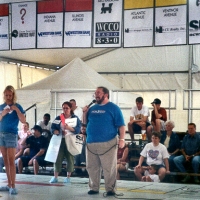 [Photo 1:  The host of the giant Monopoly game took time to talk about housing issues.]