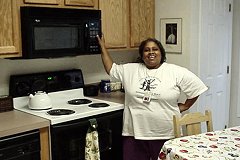 [Photo 3: Harriet in her new kitchen]