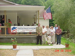 [Photo 1: Asher Family in front of their new home
