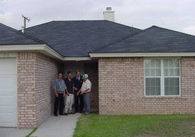 [Photo 2: Proud home owners]