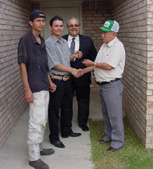 [Photo 1: Jose Luis and Jose Manuel Ramirez receive keys to their new home]