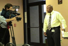 [Photo 2: Lt. Antonio Nichols demonstrates the operation of the Senior Crimestoppers Program-supplied lockbox for the news media]
