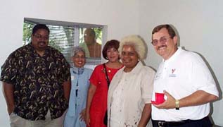 [Photo 3: The first resident of Austin's new Manor House, Sam Higgins and his mother posing with dignitaries]