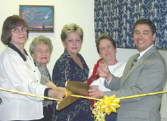 [Photo 1: Property manager, volunteer instructors and HUD official cutting the yellow ribon]
