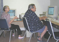 [Photo 3: Two elderly residents using Learning Center computers]