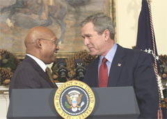 [Photo: President Bush and Alphonso Jackson at the podium]