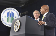 [Photo 1: President Bush and Acting Secretary Jackson standing at the podium]