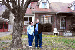 [Photo: Kevin and Nancy Miller standing in front of their home]