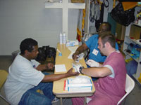 [Photo 2: Man receiving medical care]