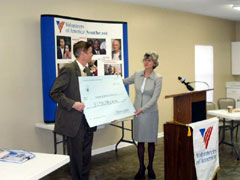 [Photo 1: Ceremonial check presentation]