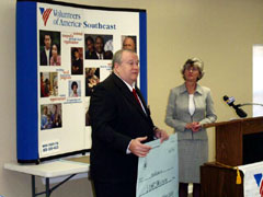 [Photo 2: Ceremonial check presentation]