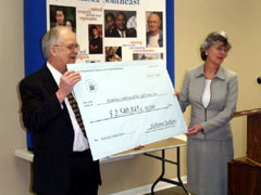 [Photo 3: Ceremonial check presentation]