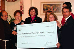 [Photo: Ceremonial check presentation]