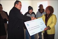 [Photo 1: HUD Regional Director Macie Houston presents check to Victor Martin, Youthbuild Director]