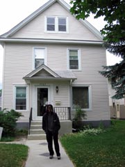 [Photo 1: Latonya in front of her new home]