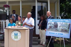 [Photo 3: Julio and Norma Rodas with their children Matthew and Stephanie at their new home.]