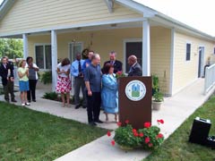 [Photo: Secretary Jackson presenting a plant to the Sears family]