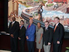 [Photo 2: People posing in front of the Energy Star promotion]