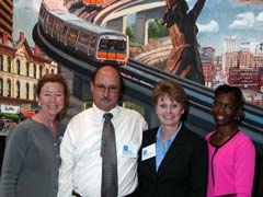[Photo 3: People posing in front of the Energy Star promotion]