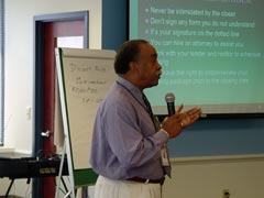 [Photo 3: Presenter at HELP presentation]