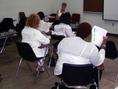 [Photo 1: "HUD At A Glance" presentation]