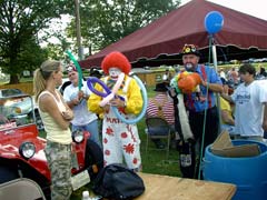 [Photo 1: Clown making balloons]