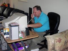 [Photo 3: David Stamps working at his desk]