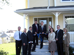 [Photo: Group at ribbon-cutting]