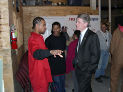 [Photo 1: HUD Regional Director Taylor Caswell speaking with Roman H.]
