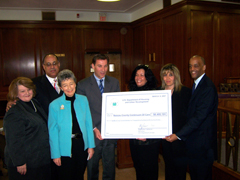 [Photo: Group picture with check]