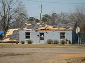 [Photo 6: Home suffered extensive damage including a partial collapse of its roof]