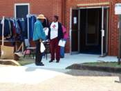 [Photo 14: Red Cross volunteers distribute replacement clothing from local churches]