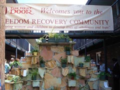 [Photo 1: An artful stone backdrop in the Freedom Recovery Community courtyard]