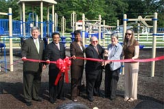 [Photo: Group cutting ribbon]