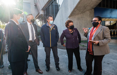 [Secretary Fudge speaks with (left to right) CEO of East Bay Asian Local Development Corporation Andy Madeira, CEO of Unity Council Chris Iglesias, Oakland Councilmember Noel Gallo, and U.S. Representative Barbara Lee in Oakland, California.]