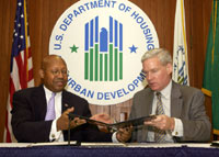 [Photo: Commissioner Mark W. Everson and HUD Secretary Alphonso Jackson signing partnership agreement]