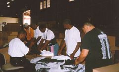 Photo of volunteers processing clothing at the Resource Bank