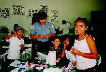 Photo of children and police officer enjoying craft activities